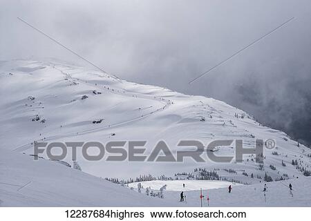 Stock Photograph - Skiers on a mountain; Whistler, British Columbia, Canada. Fotosearch