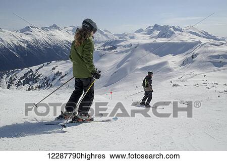 Stock Photograph - Skiing down resort ski hill; Whistler, British Columbia, Canada. Fotosearch
