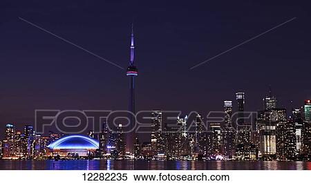 Skyline of Toronto and CN tower illuminated at night and reflected in Lake Ontario; Toronto, Ontario, Canada View Large Photo Image Stock Photography - Skyline of Toronto and CN tower illuminated at night and reflected in Lake Ontario; Toronto, Ontario, Canada. Fotosearch