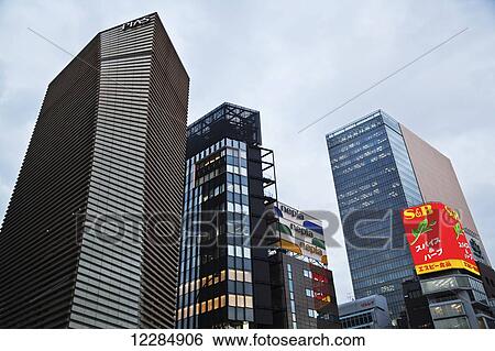 Stock Photograph - Skyscrapers against a cloudy sky; Tokyo, Japan. Fotosearch