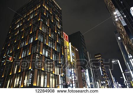 Stock Photo - Skyscrapers illuminated at nighttime; Tokyo, Japan. Fotosearch