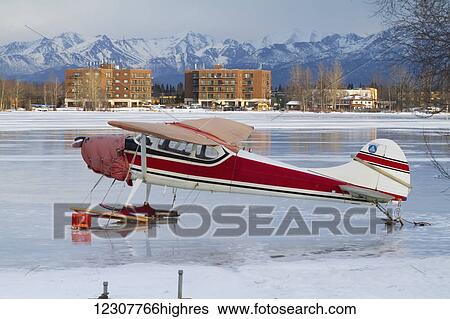 Stock Photograph - Small plane with skis on Lake Hood in Anchorage in Southcentral Alaska, Winter.. Fotosearch