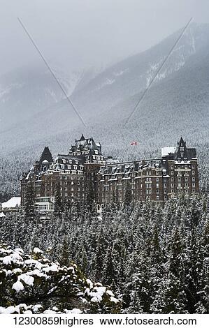 Snow covered Banff Springs Hotel with snow covered trees on mountain hillside in the background; Banff, Alberta, Canada View Large Photo Image Stock Photograph - Snow covered Banff Springs Hotel with snow covered trees on mountain hillside in the background; Banff, Alberta, Canada. Fotosearch
