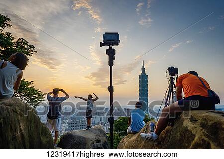 Stock Photograph - Some tourist taking pictures of Taipei from Elephant mountain; Taipei, Taiwan, China. Fotosearch