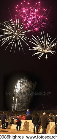 Stock Photograph - Spectators watching colourful fireworks display at nighttime; South Shields, Tyne and Wear, England. Fotosearch