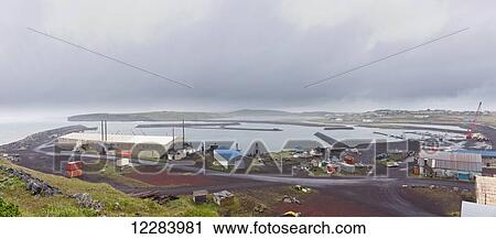 Stock Image - St. Paul harbor, industrial cranes, and port warehouse, St. Paul Island, Southwestern Alaska, USA, Summer. Fotosearch