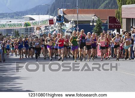 Stock Photograph - Start of the women's race of the Mt. Marathon race, 4th of July, 2014 in Seward, Southcentral Alaska, USA. Fotosearch