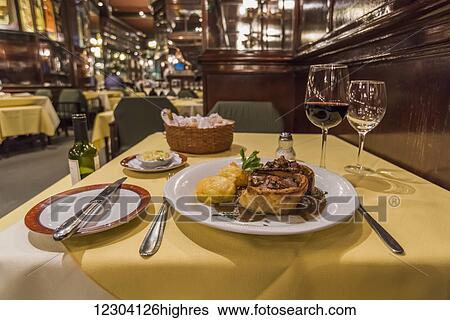 Stock Photograph - Steak dinner and wine on restaurant table; Buenos Aires, Argentina. Fotosearch