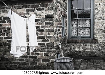 Stone walls of a house with laundry hanging to dry on the clothesline; Beamish, Durham, England View Large Photo Image Stock Photograph - Stone walls of a house with laundry hanging to dry on the clothesline; Beamish, Durham, England. Fotosearch