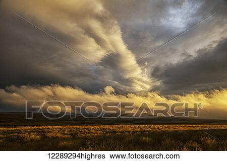 Stock Photograph - Storm clouds illuminated over the northeastern region of Iceland; Iceland. Fotosearch