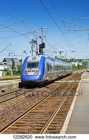 Streamline electric train on tracks at a station platform with blue sky; Morlaix, Brittany, France View Large Photo Image Stock Image - Streamline electric train on tracks at a station platform with blue sky; Morlaix, Brittany, France. Fotosearch