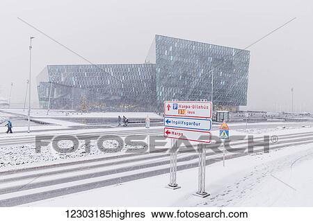 Street scene in front of the Harpa Public Concert Hall during a snow storm, designed by the Danish firm Henning Larsen Architects and Icelandic firm Batteriao Architects, the glass facade is designed by Icelandic artist Olafur Eliasson; Reykjavik, Iceland View Large Photo Image Stock Photograph - Street scene in front of the Harpa Public Concert Hall during a snow storm, designed by the Danish firm Henning Larsen Architects and Icelandic firm Batteriao Architects, the glass facade is designed by Icelandic artist Olafur Eliasson; Reykjavik, Iceland. Fotosearch