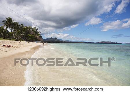 Stock Photograph - Sunbathing at Kaiona Beach Park; Waimanalo, Oahu, Hawaii, United States of America. Fotosearch