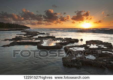 Sunrise over surf and a lava reef; Kauai, Hawaii, United States of America View Large Photo Image Stock Photograph - Sunrise over surf and a lava reef; Kauai, Hawaii, United States of America. Fotosearch