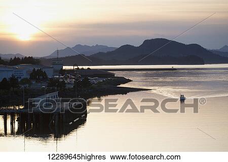 Stock Photograph - Sunset over Sikta Harbor, Southeast Alaska, USA, summer. Fotosearch