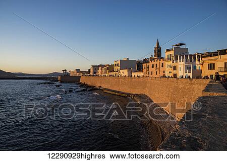 Stock Photograph - Sunset over the Catalan wall; Alghero, Sardinia, Italy. Fotosearch