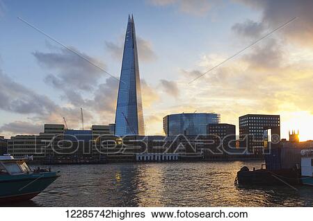 Stock Photograph - Sunset view across the river Thames, including the Shard; London, England. Fotosearch