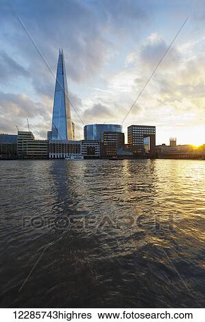 Stock Photograph - Sunset view across the river Thames, including the Shard; London, England. Fotosearch