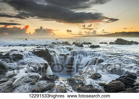 Surf spills into a hole in a rock outcrop on the east side of Kauai; Kauai, Hawaii, United States of America View Large Photo Image Stock Photograph - Surf spills into a hole in a rock outcrop on the east side of Kauai; Kauai, Hawaii, United States of America. Fotosearch
