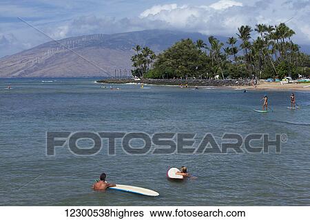 Surfers, stand up paddlers, Cove Park Beach, West Maui Mountains in the distance; Kihei, Maui, Hawaii, United States of America View Large Photo Image Stock Photograph - Surfers, stand up paddlers, Cove Park Beach, West Maui Mountains in the distance; Kihei, Maui, Hawaii, United States of America. Fotosearch