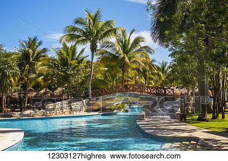 Swimming pool and footbridge at a resort on the Caribbean; Playa del Carmen, Quintana Roo, Mexico View Large Photo Image Stock Photograph - Swimming pool and footbridge at a resort on the Caribbean; Playa del Carmen, Quintana Roo, Mexico. Fotosearch