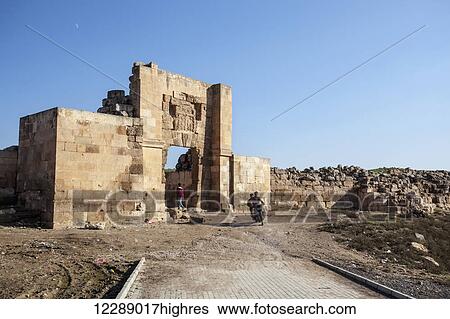 Stock Photograph - Tell Haran, located in the fertile Haran Plain, which is watered by the Balikh River, a major tributary of the Euphrates River. Only the western gate, the Aleppo Gate, remains standing; Harran, Turkey. Fotosearch