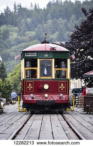 Stock Image - The Astoria Trolley running along the riverfront; Astoria, Oregon, United States of America. Fotosearch