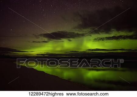 The Aurora Borealis colors the sky above Marsh Lake in mid April, Yukon, Canada. View Large Photo Image Stock Photograph - The Aurora Borealis colors the sky above Marsh Lake in mid April, Yukon, Canada.. Fotosearch