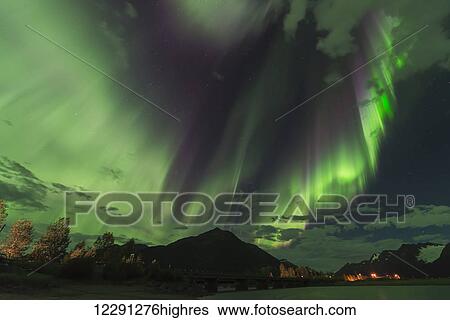 The aurora borealis dances over the Seward Highway and 20 Mile River south of Girdwood, Alaska. View Large Photo Image Stock Photograph - The aurora borealis dances over the Seward Highway and 20 Mile River south of Girdwood, Alaska.. Fotosearch