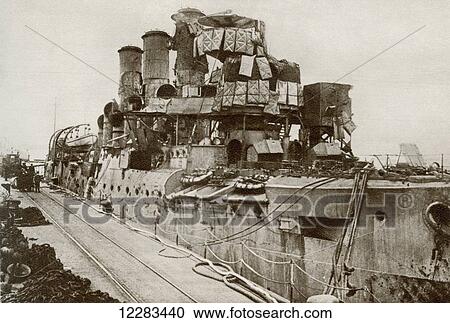 Stock Image - The battleship Vindictive returns to Dover after the raid on Zeebrugge in 1918 during World War One. From The Story of 25 Eventful Years in Pictures published 1935. Fotosearch
