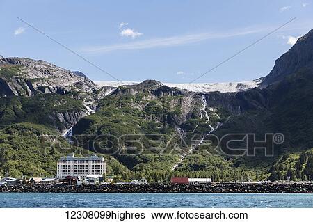 Stock Photograph - The City of Whittier and the Begich Towers seen from the Ocean on a clear Sunny day, Whittier, South Central Alaska, USA, Summer. Fotosearch