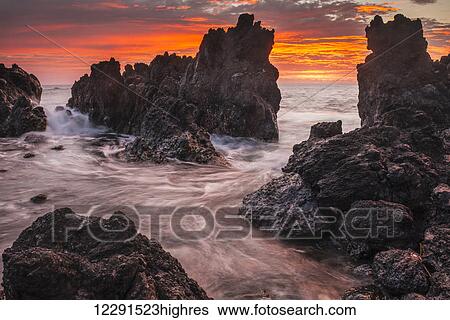 The colours of sunrise behind coastal lava rocks; Laupahoehoe, Island of Hawaii, Hawaii, United States of America View Large Photo Image Stock Photograph - The colours of sunrise behind coastal lava rocks; Laupahoehoe, Island of Hawaii, Hawaii, United States of America. Fotosearch