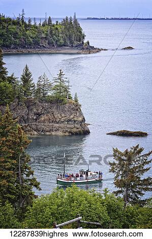 Stock Photograph - The Danny J Kachemak Bay Ferry cruises into Halibut Cove in Kachemak Bay, Southcentral Alaska, Summer. Fotosearch