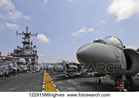The nose of an AV-8B Marine Harrier II sticks out among other Harriers and a row of CH-46 Sea Knight helicopters onboard the USS Peleliu (LHA-5); San Diego, California, United States of America View Large Photo Image Stock Photograph - The nose of an AV-8B Marine Harrier II sticks out among other Harriers and a row of CH-46 Sea Knight helicopters onboard the USS Peleliu (LHA-5); San Diego, California, United States of America. Fotosearch
