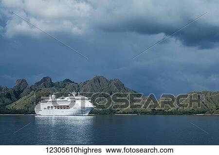 Stock Photograph - The Pacific Jewel off Komodo Island, a cruise ship operated by the P&O cruise line, holding up to 1, 950 guests and has 11 guest decks; Flores, Indonesia. Fotosearch