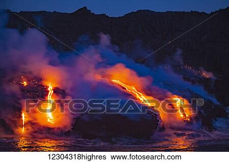 Stock Photograph - The Pahoehoe lava flowing from Kilauea has reached the Pacific ocean near Kalapana; Island of Hawaii, Hawaii, United States of America. Fotosearch