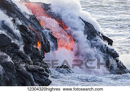 Stock Photograph - The Pahoehoe lava flowing from Kilauea has reached the Pacific ocean near Kalapana; Island of Hawaii, Hawaii, United States of America. Fotosearch