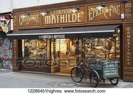 The richly decorated facade of a traditional chocolate store with antique delivery cart in front; Paris, France View Large Photo Image Stock Photograph - The richly decorated facade of a traditional chocolate store with antique delivery cart in front; Paris, France. Fotosearch