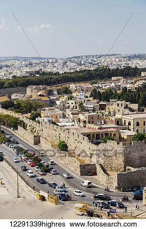 The walled city in the Port of Rhodes, a tourist attraction and cruise ship destination on the Greek Islands; Mandraki, Rhodes, Greece View Large Photo Image Stock Photograph - The walled city in the Port of Rhodes, a tourist attraction and cruise ship destination on the Greek Islands; Mandraki, Rhodes, Greece. Fotosearch