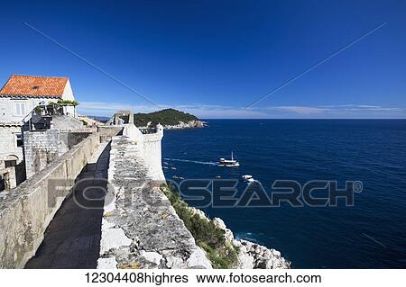 Stock Photograph - The Walls of Dubrovnik surround the old city of Dubrovnik and provide stunning scenery and vantage points around the city; Dubrovnik, Croatia. Fotosearch