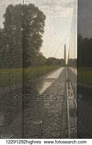 Stock Photograph - The Washington Monument reflects in the surface of the wall at the Vietnam Veterans Memorial; Washington, District of Columbia, United States of America. Fotosearch