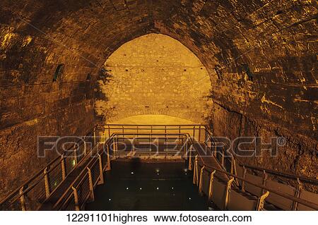 Stock Photograph - The Western Wall Tunnel, an underground tunnel exposing the full length of the Western Wall; Jerusalem, Israel. Fotosearch
