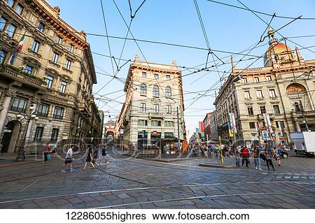 This popular tourist road is intersected by the lines of the electric buses and tram cars that carry tourists to sightseeing desitantions down the cobblestone streets in historic Milan; Milan, Italy View Large Photo Image Stock Photograph - This popular tourist road is intersected by the lines of the electric buses and tram cars that carry tourists to sightseeing desitantions down the cobblestone streets in historic Milan; Milan, Italy. Fotosearch