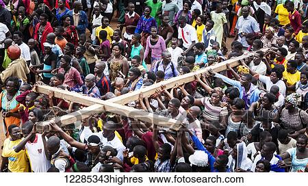 Thousands gather on Good Friday to walk through the streets and proclaim the Gift of God; Gulu, Uganda View Large Photo Image Stock Photograph - Thousands gather on Good Friday to walk through the streets and proclaim the Gift of God; Gulu, Uganda. Fotosearch
