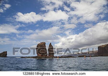 Three young people on stand-up paddle boards at Needles off the island of Lanai; Hawaii, United States of America View Large Photo Image Stock Photograph - Three young people on stand-up paddle boards at Needles off the island of Lanai; Hawaii, United States of America. Fotosearch