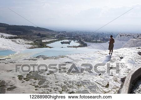 Stock Photograph - Tourist at the mineral rich pools and hot springs; Pamukkale, Turkey. Fotosearch