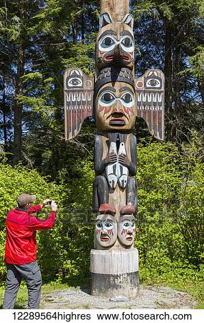Tourist photographs a totem pole, Totem Bight Historic State Park, Ketchikan, Southeast Alaska, USA, Spring View Large Photo Image Stock Photograph - Tourist photographs a totem pole, Totem Bight Historic State Park, Ketchikan, Southeast Alaska, USA, Spring. Fotosearch