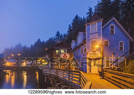 Stock Photograph - Tourist shops and homes along Creek Street in downtown Ketchikan on a foggy evening, Southeast Alaska, USA, Spring, HDR. Fotosearch
