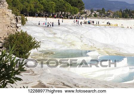 Stock Photograph - Tourists at the mineral rich pools and hot springs; Pamukkale, Turkey. Fotosearch