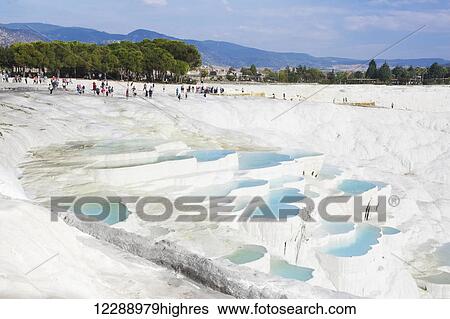 Stock Photograph - Tourists at the mineral rich pools and hot springs; Pamukkale, Turkey. Fotosearch